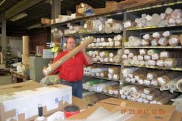 Steve Thayer, President of Thayercraft with short rolls of fiberglass cloth 